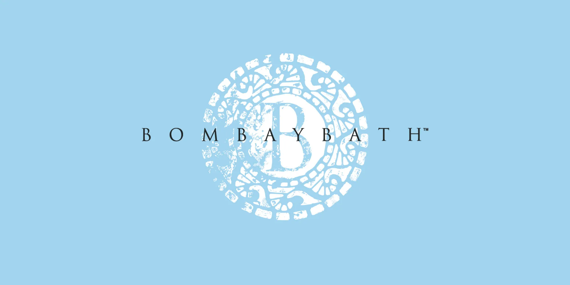 Bombay Bath wordmark with a mosaic-tile medallion B on a pale blue field.
