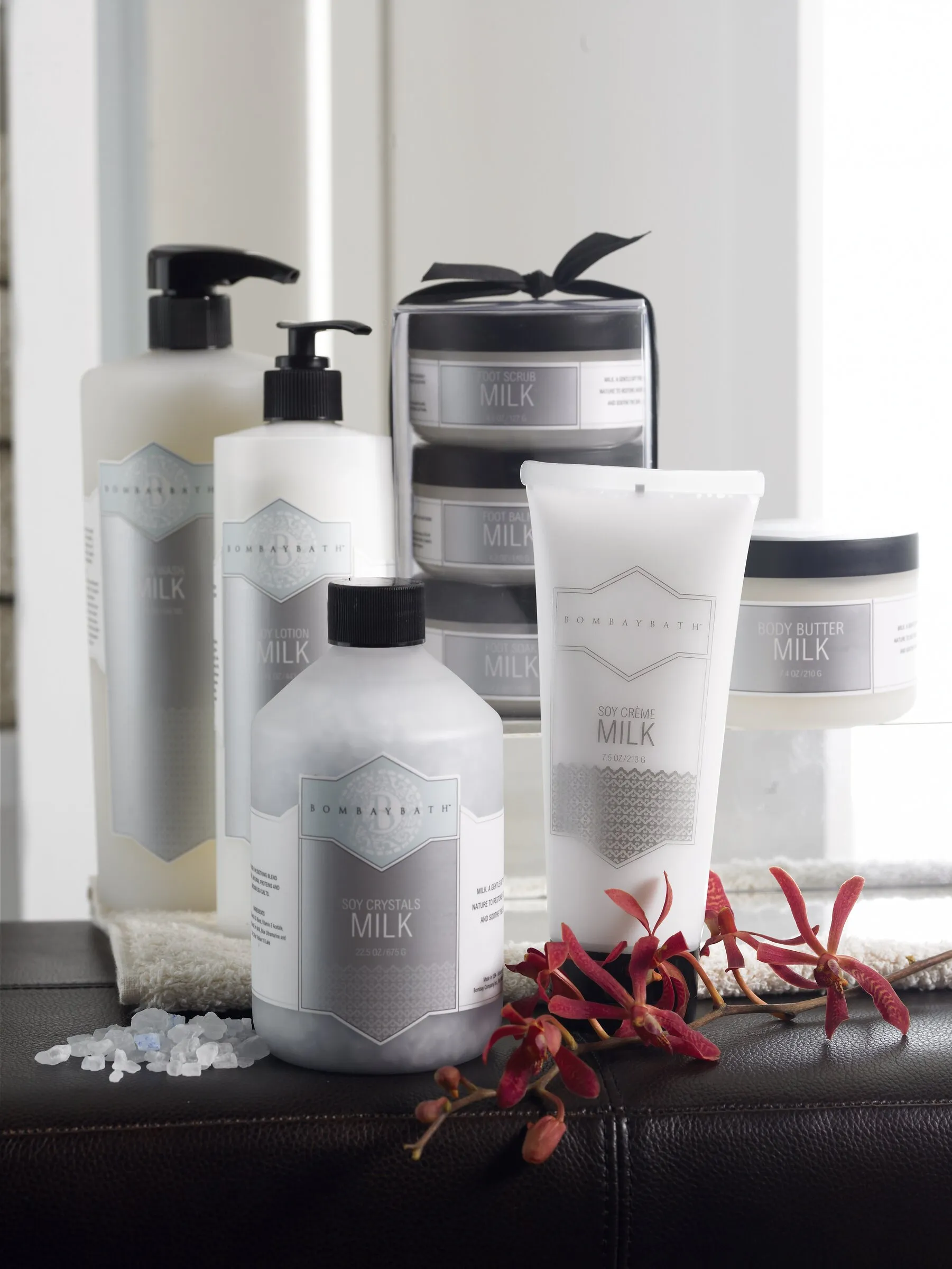 Bombay Bath 'Milk' collection packaging — body wash, lotion, crème, and body butter in silver-and-white bottles and jars.