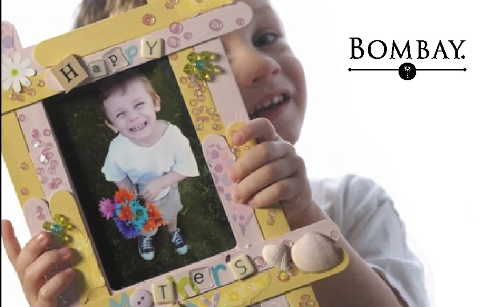 Bombay Mother's Day brochure cover — a child holding a handmade 'Happy Mother's Day' photo frame.